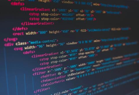 Several lines of code written in multi-colored font against a dark background.